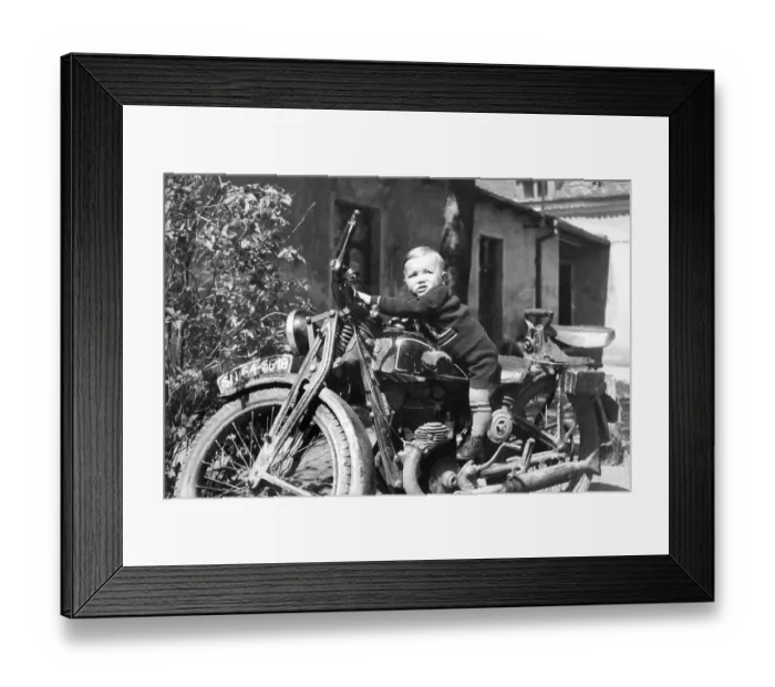 Framed Print : Small child on a motorbike, historical photo Framed Print : Small child on a motorbike, historical photo