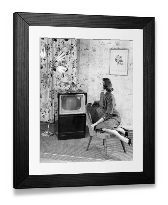 Framed Print : Woman posing next to a television