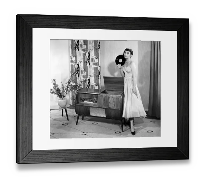 Framed Print : Woman posing next to a record player