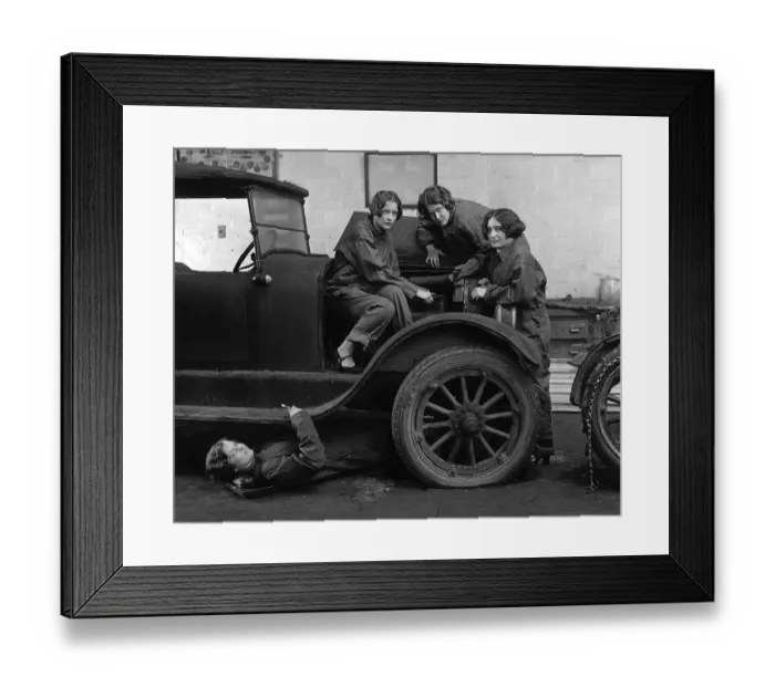 Framed Print : Female car mechanics fixing a car
