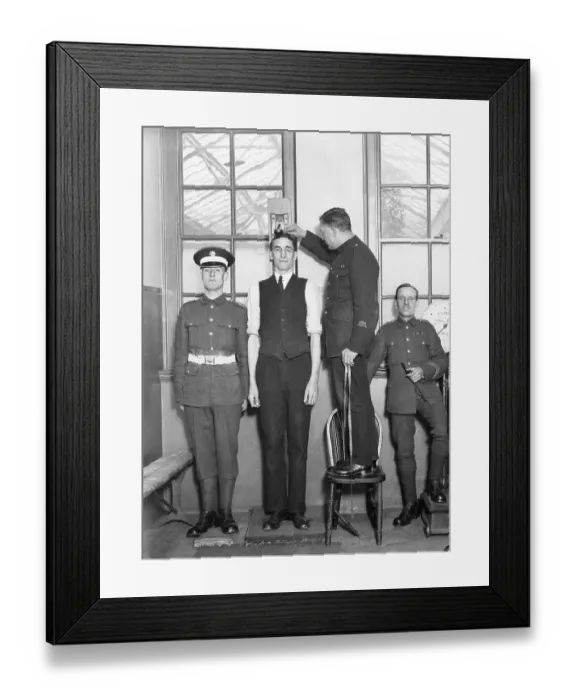 Framed Print : Tall man being measured, army physical Framed Print : Tall man being measured, army physical