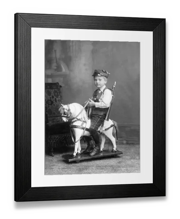 Framed Print : Historic photograph, young boy sitting on a rocking horse Framed Print : Historic photograph, young boy sitting on a rocking horse