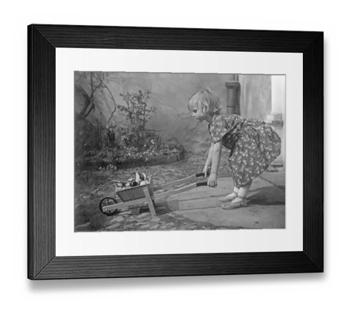 Framed Print : Girl playing, historical image, ca. 1931 Framed Print : Girl playing, historical image, ca. 1931