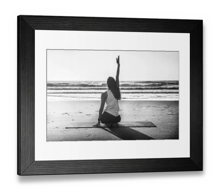 Framed Print : Rearview shot of a young woman practicing yoga at the beach Framed Print : Rearview shot of a young woman practicing yoga at the beach