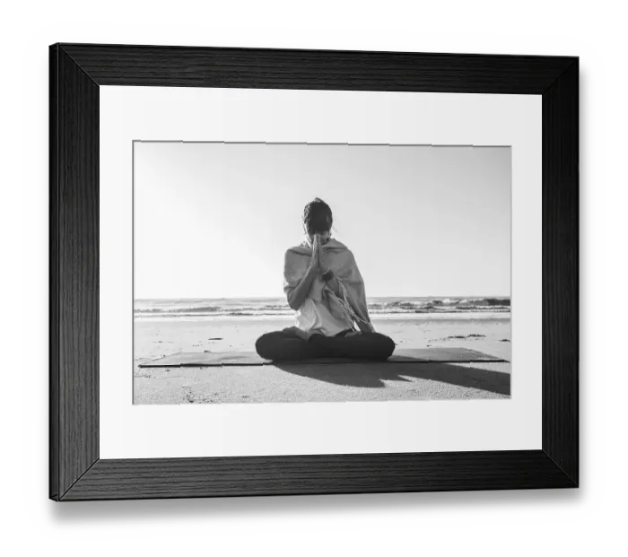 Framed Print : Portrait of a woman clasping hands while holding a japa mala at the beach