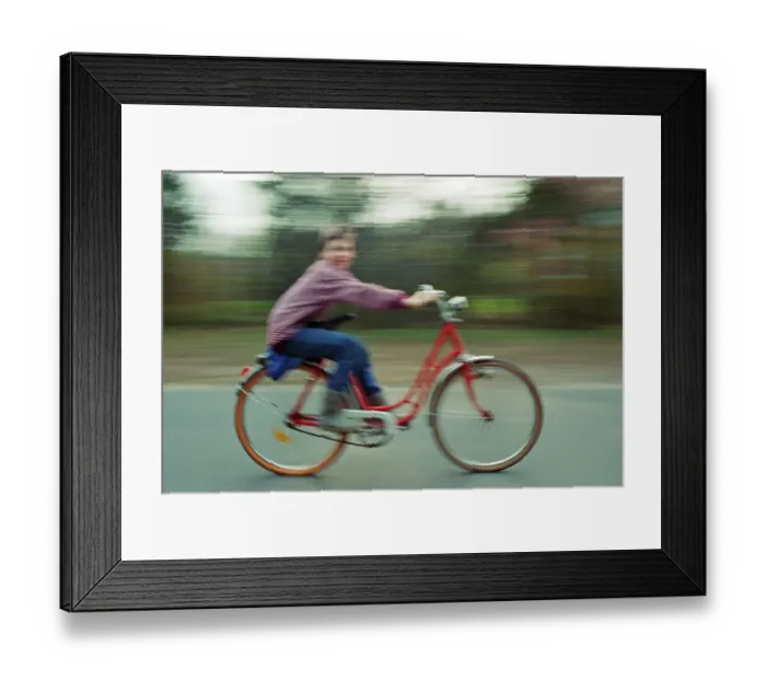 Framed Print : Boy riding bicycle, motion blur Framed Print : Boy riding bicycle, motion blur