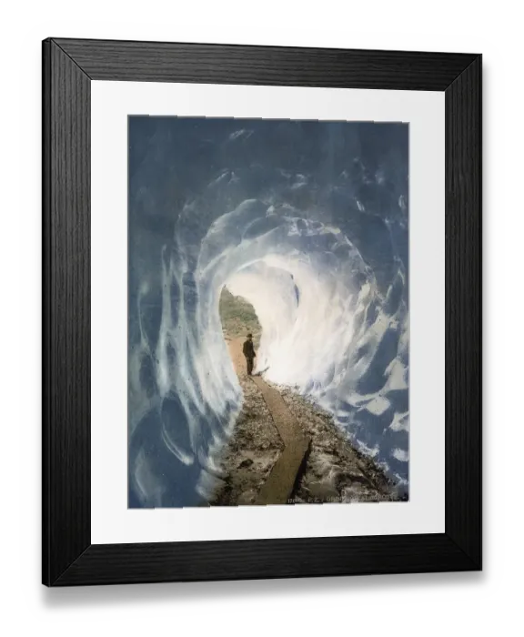 Framed Print : A man standing at the entrance to an ice cave at the Grindelwald Grotto Framed Print : A man standing at the entrance to an ice cave at the Grindelwald Grotto