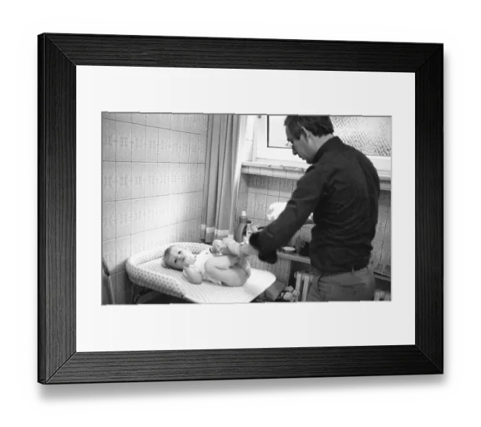 Framed Print : The care of a small child by the father was rather rare in 1980