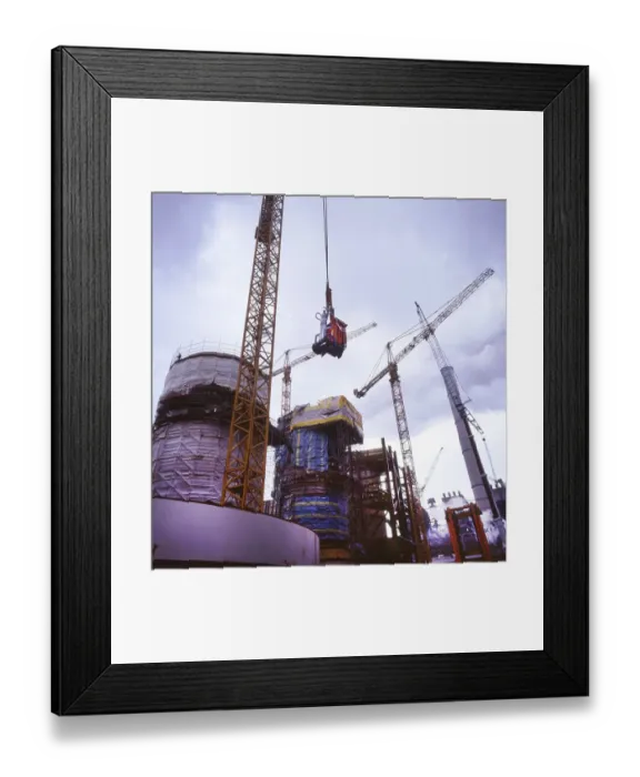 Framed Print : Workmen building a coal-fired power plant