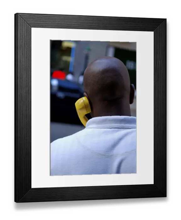 Framed Print : Coloured New Yorker talking on the phone with a yellow handset