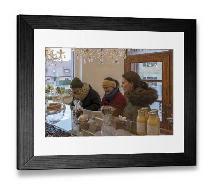 Framed Print : Young woman shopping in a bakery