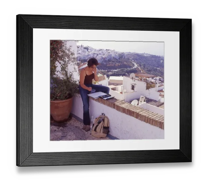 Framed Print : Female artist sits on a wall and draws in Frigiliana Framed Print : Female artist sits on a wall and draws in Frigiliana
