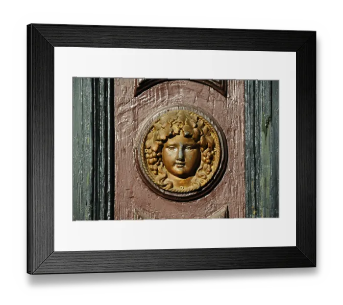 Framed Print : Womans head in relief on an old house door