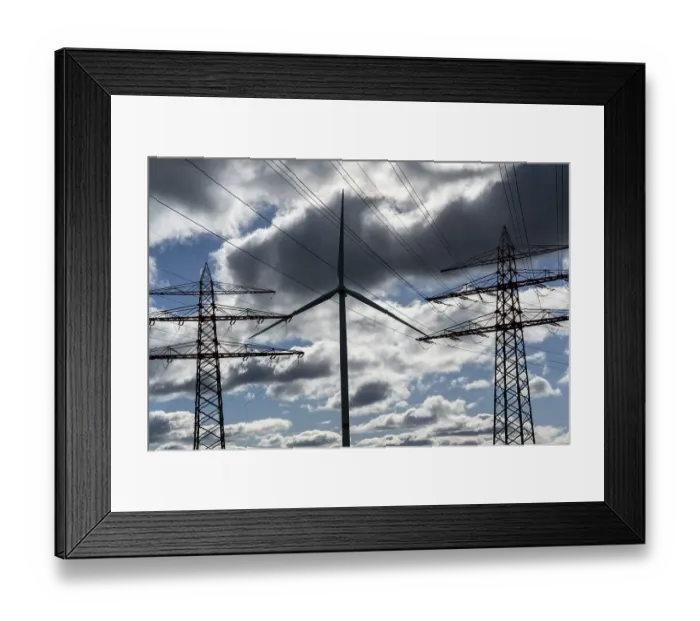 Framed Print : Wind turbine, high-voltage pylons