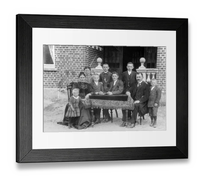 Framed Print : Portrait, family sitting at a table and looking into the camera