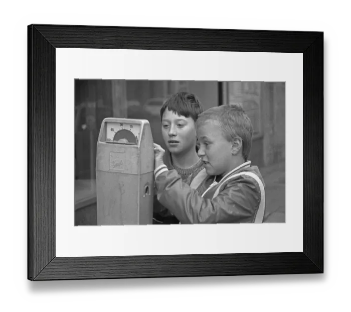 Framed Print : Two boys examining a parking meter Framed Print : Two boys examining a parking meter