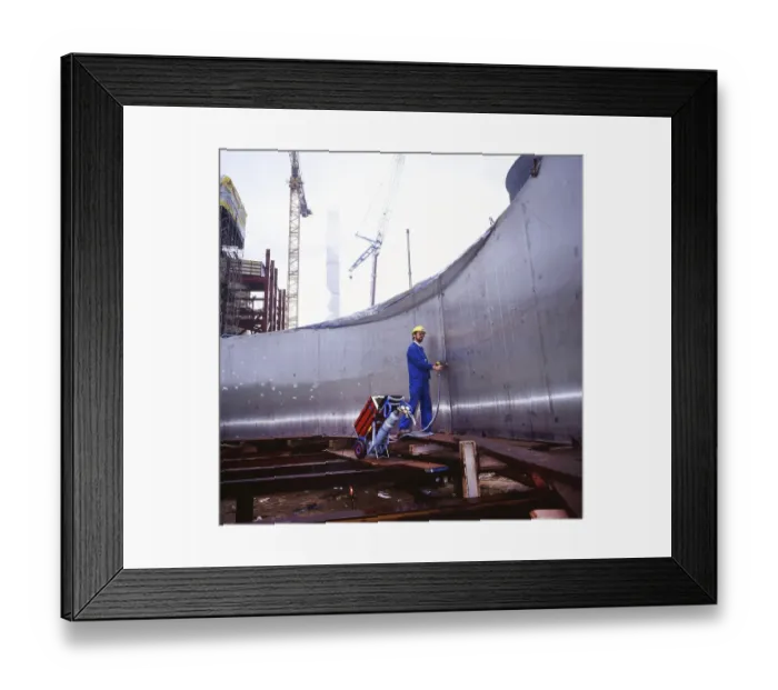 Framed Print : Workmen building a coal-fired power plant