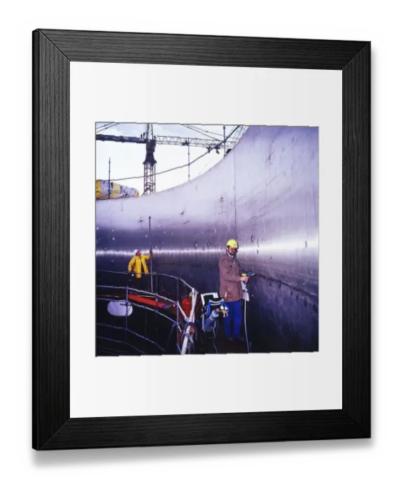 Framed Print : Workmen building a coal-fired power plant