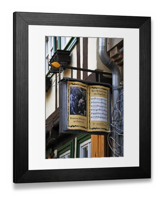 Framed Print : Opened, old songbook as advertising sign of a bookshop Framed Print : Opened, old songbook as advertising sign of a bookshop