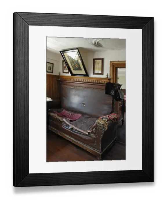 Framed Print : Sofa with saints border in the living room with a view into the sleeping chamber Framed Print : Sofa with saints border in the living room with a view into the sleeping chamber