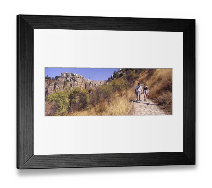 Framed Print : Young couple walking on a path in the valley at Ronda