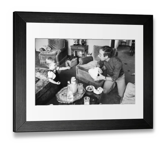 Framed Print : The care of a small child by the father was rather rare in 1980 Framed Print : The care of a small child by the father was rather rare in 1980