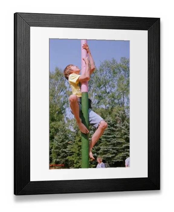 Framed Print : Boy climbs on maypole, barefoot