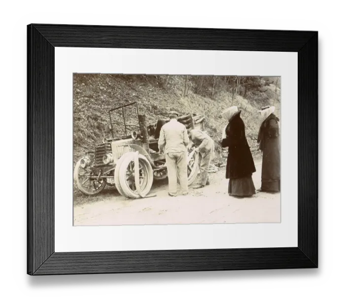 Framed Print : History of the Automobile, The travelling party observes the changing of the car's tyres