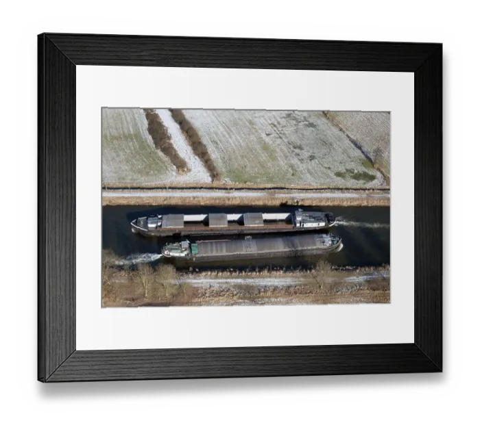 Framed Print : Aerial view of two barges in the Elbe Luebeck Canal in winter Framed Print : Aerial view of two barges in the Elbe Luebeck Canal in winter