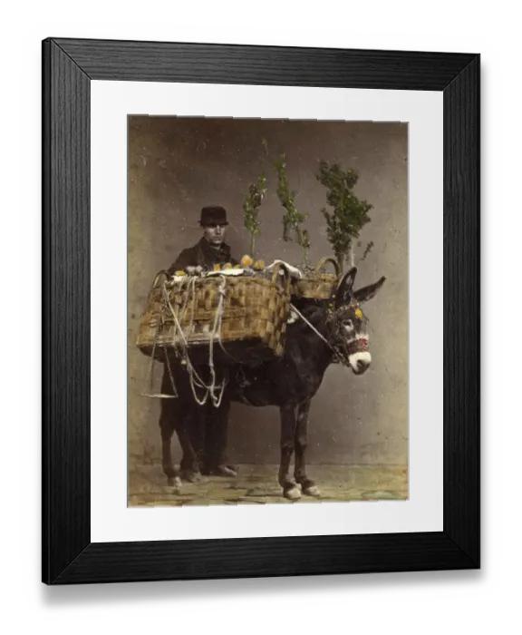 Framed Print : A man, farmer, with a loaded donkey on the way to the market