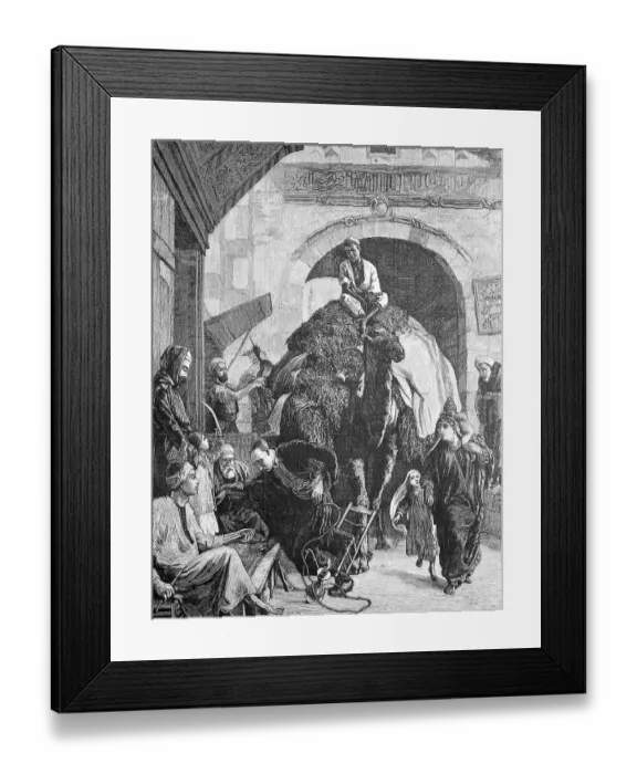 Framed Print : A street in cairo, a merchant with a loaded camel rides through the gate Framed Print : A street in cairo, a merchant with a loaded camel rides through the gate