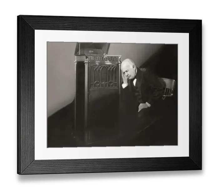 Framed Print : Thomas Alva Edison listening to his disc phonograph