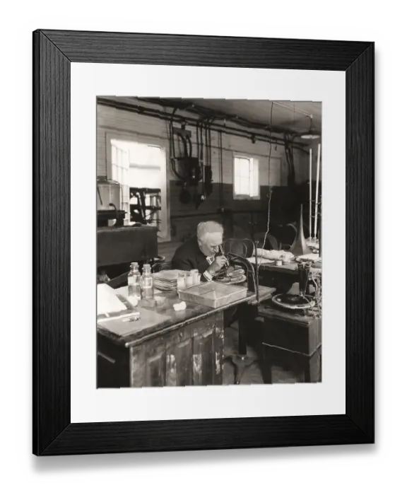 Framed Print : Thomas Alva Edison examining a phonograph disc under a microscope