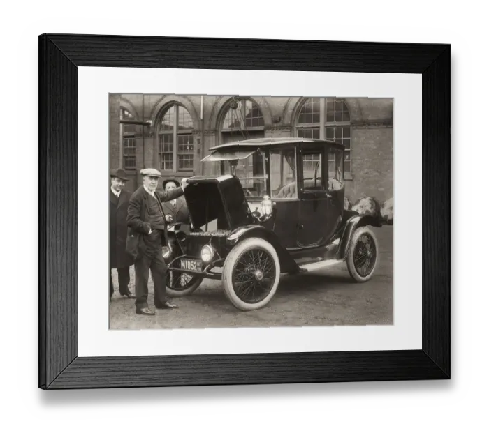 Framed Print : Thomas Alva Edison displaying storage batteries of the power Detroit Electric automobile