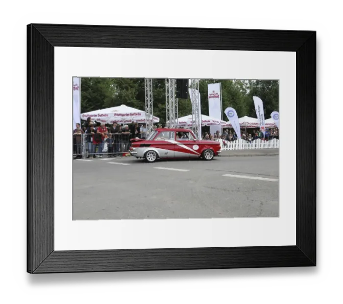 Framed Print : A red and white vintage car drives past enthusiastic spectators on a rally route Framed Print : A red and white vintage car drives past enthusiastic spectators on a rally route