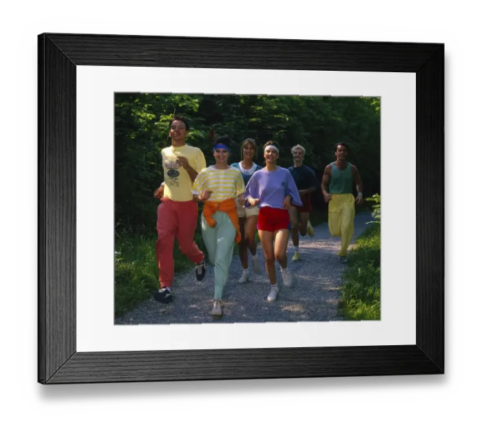 Framed Print : Young people jogging through flower meadow