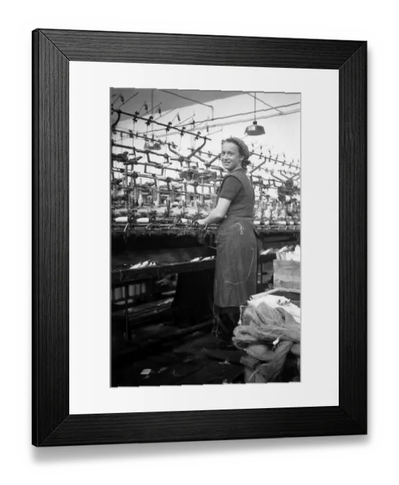 Framed Print : Textile industry, woman works in a spinning mill
