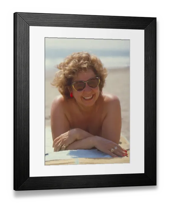Framed Print : Older woman on the beach, recumbent with the solar bath Framed Print : Older woman on the beach, recumbent with the solar bath