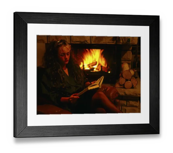 Framed Print : Woman by the fireplace, with book