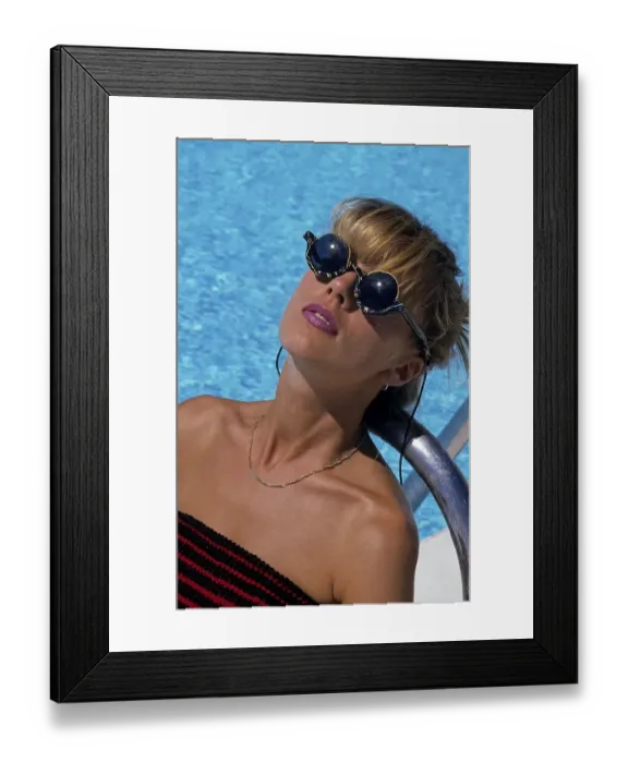 Framed Print : Young woman at the swimming pool