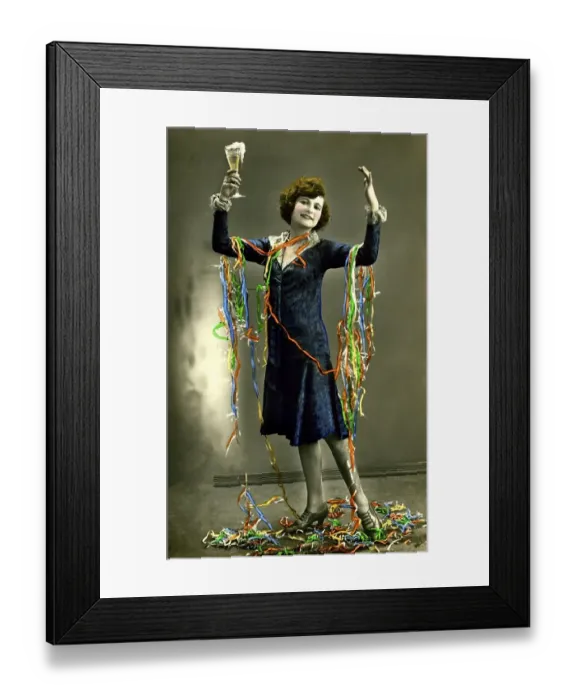Framed Print : Woman celebrates New Year's Eve with champagne and paper snakes Framed Print : Woman celebrates New Year's Eve with champagne and paper snakes