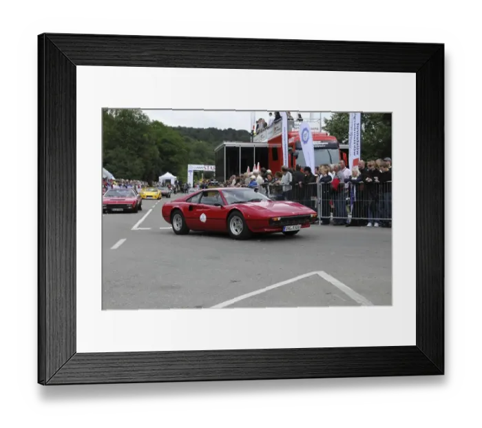 Framed Print : A red classic car at a motorsport event in front of an enthusiastic audience
