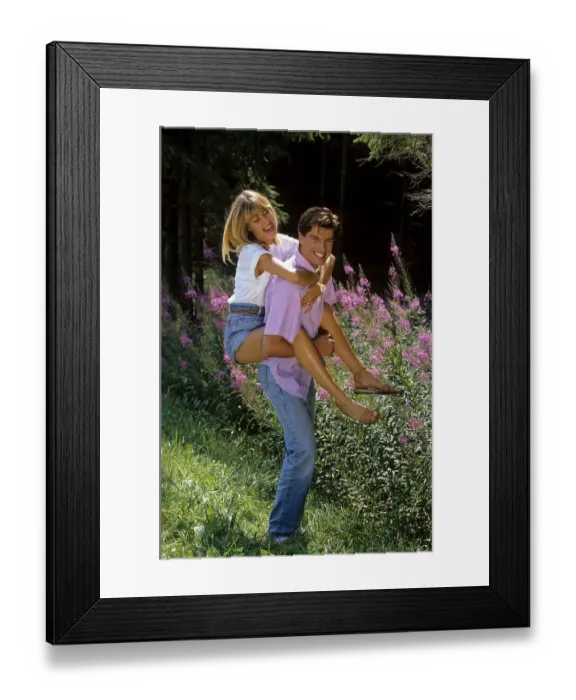 Framed Print : Young woman embraces young man walking in the forest Framed Print : Young woman embraces young man walking in the forest
