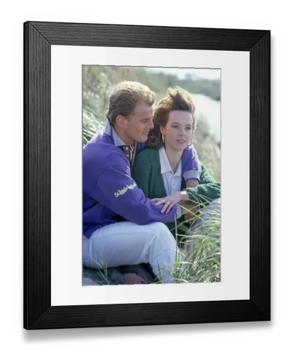 Framed Print : Lovers sitting in the grass, with cardigan Framed Print : Lovers sitting in the grass, with cardigan