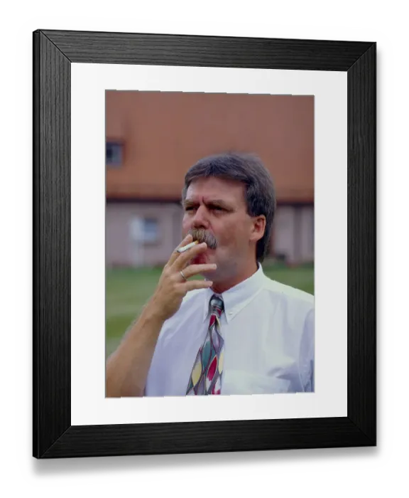 Framed Print : Man smokes cigarette outdoors