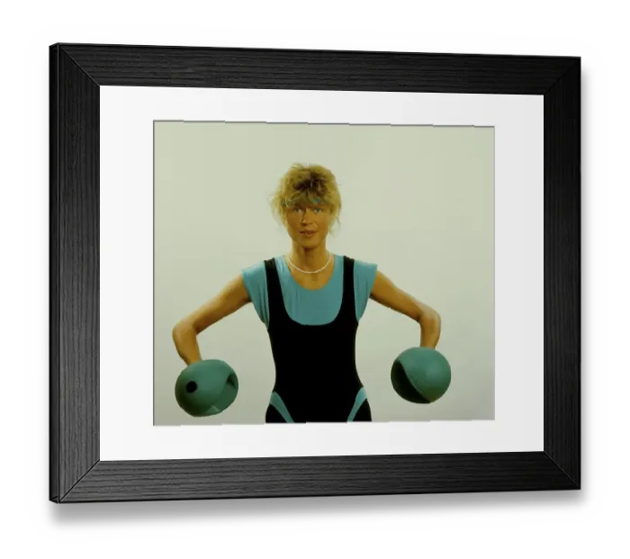 Framed Print : Young woman doing gymnastics with dumbbells
