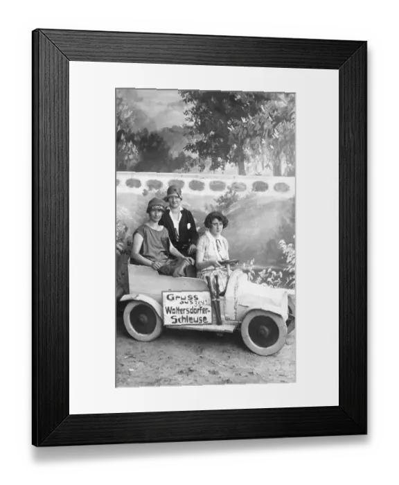 Framed Print : Three women in a small car made of wood