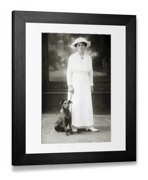 Framed Print : Dog next to woman in white dress