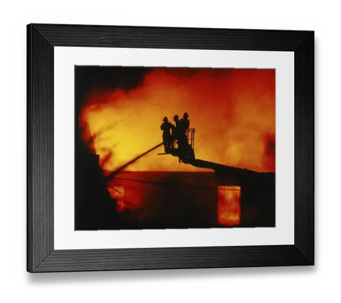 Framed Print : Firefighters extinguish a fire