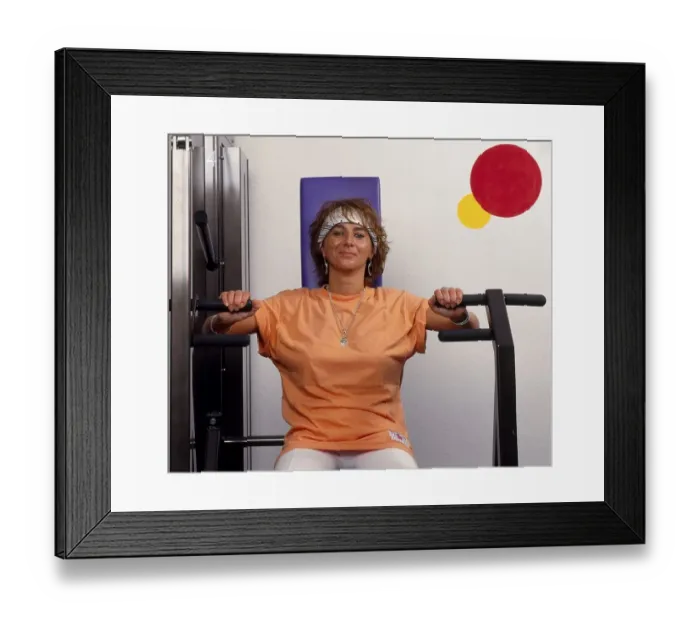 Framed Print : Young woman in the gym doing a chest squeeze Framed Print : Young woman in the gym doing a chest squeeze
